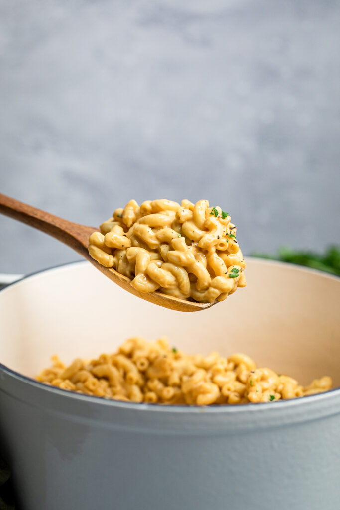 15 minute easy vegan macaroni and cheese on a wooden spoon.