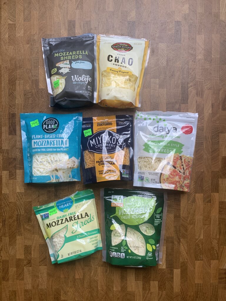 A table of vegan shredded cheese packages. 