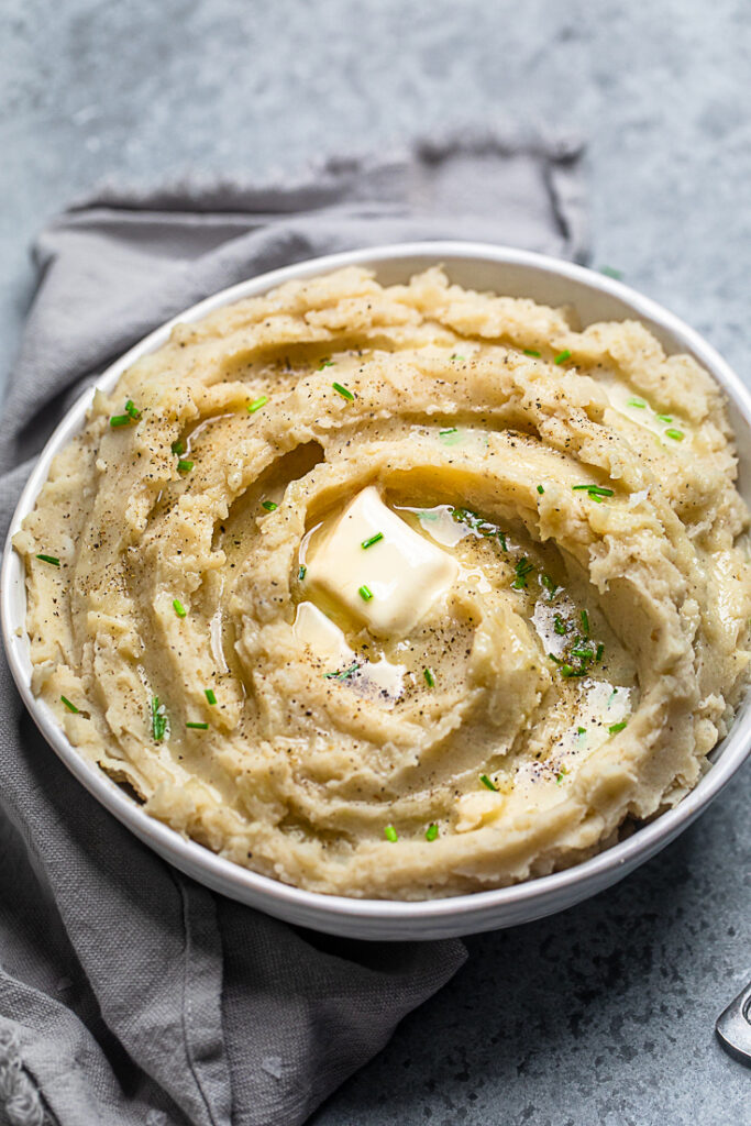 A white bowl of 30-minute vegan mashed potatoes and gravy. 